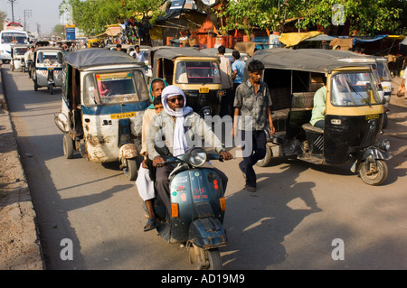 Eine typische chaotischen Straßenszene in Varanasi mit Auto-Rikschas (Tuk Tuks), Motorroller und Menschen auf den belebten Straßen. Stockfoto