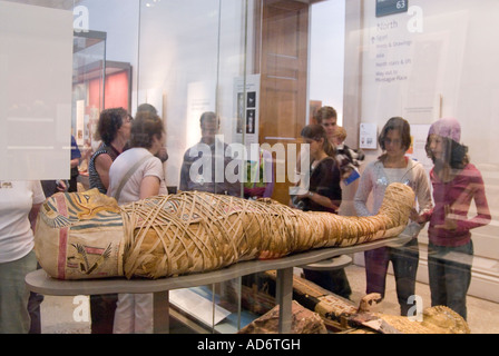 Besucher betrachten einer alten ägyptischen Mumie im British Museum London England UK Stockfoto