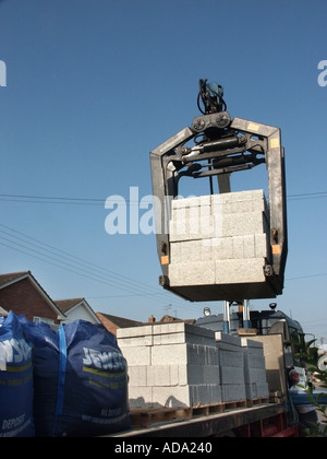 Mechanische Entladung LKW der Ladung von Betonblöcken von der Palette auf die Baustelle mit Cormach Kran Essex England UK angehoben Stockfoto