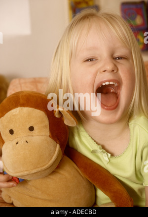 Hübsches junges Mädchen Kuscheln ein Stofftier-Geschrei Stockfoto