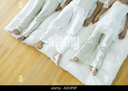 Gruppentherapie, drei Erwachsene nebeneinander liegend Stockfoto