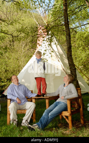 Familiengruppe auf Campingurlaub im Zelt am Spezialist Tipi Campingplatz am Bauernhof in Mid Wales UK Stockfoto