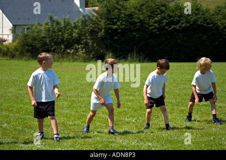 Grundschule jungen immer bereit für die Sprint-Rennen auf dem Schulsporttag. Stockfoto