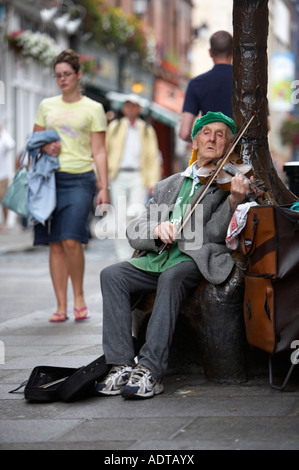 alte irische Mann spielt die Geige für Geld sitzen in touristische Fußgängerzone von Temple Bar dublin Stockfoto