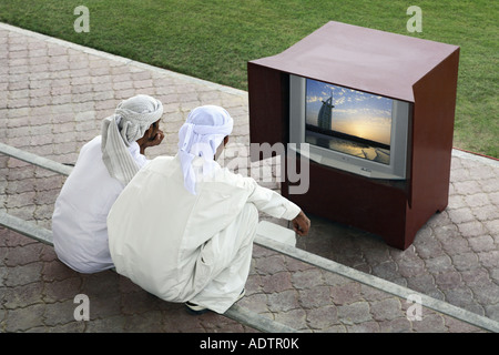 zwei arabische Männer vor dem Fernseher, Dubai (Bild im Fernsehen ist von mir) Stockfoto