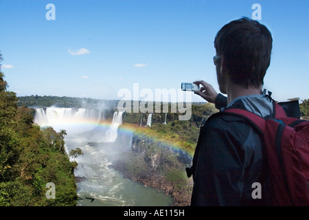 Junge männliche unter Bild von Iguazu fällt auf seine Kamera-Handy Stockfoto