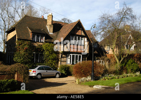 Vorgarten eines großen Einfamilienhauses mit roten Kies Einfahrt und