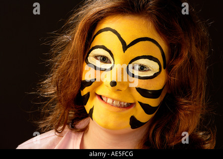 Porträt von Mädchen (9-10 Jahre) mit Hummeln oder Wespen Gesicht malen Stockfoto