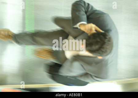 Erhöhte Ansicht der Geschäftsmann auf Rolltreppe im Gespräch Stockfoto