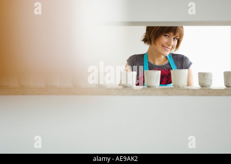 Junge Frau Lächeln für die Kamera in Küche Stockfoto