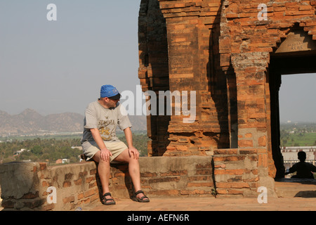 Mann, sitzend auf den Resten der Po Klong Garai Cham Türme in Vietnam Stockfoto