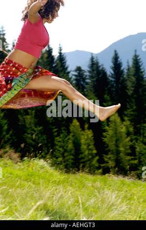 Junge Frau springen, seitliche Ansicht Stockfoto