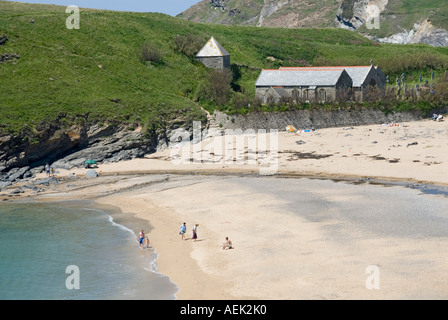 Denkmalgeschütztes Gebäude der Parish Church of Saint Winwaloe in Gunwalloe und der freistehende Glockenturm in Strandlandschaft in Church Cove Cornwall England Stockfoto