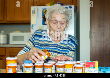 85 Jahre alten senior weiblichen Show Frustration bei Trennung Medizin in einen Behälter Stockfoto