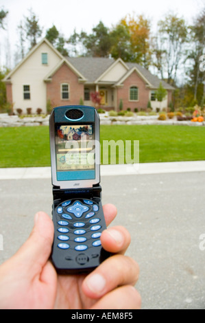 Telefon Handy wird verwendet, um ein Bild von einem Heim von einem Immobilienmakler Stockfoto