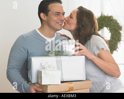 Frau Mann, hält Weihnachtsgeschenke küssen Stockfoto