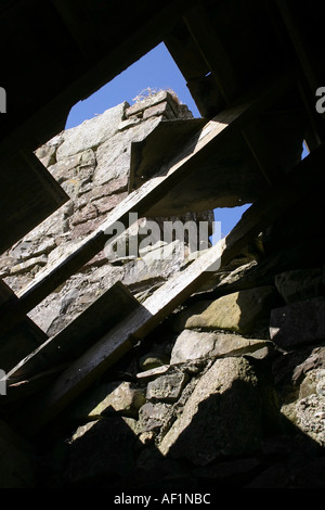 Blick in den Himmel durch das Dach eines verlassenen Steingebäudes Stockfoto