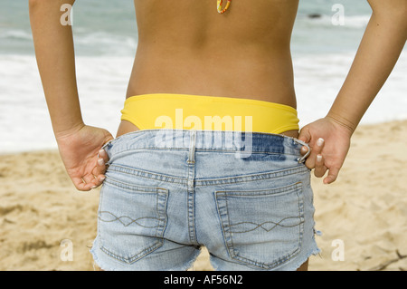 Mid section view of a woman getting dressed Stockfoto