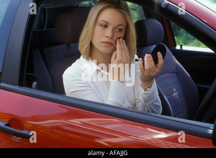 Frau auf Make-up in ihrem Auto Stockfoto