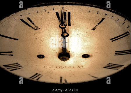 Antike Uhr Gesicht mit den Händen am 12 o Uhr dunkel und körnig Sepia getönt Bild Stockfoto