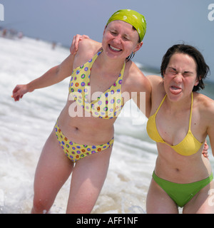 zwei junge Frauen posieren im Ozean Stockfoto