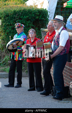 Musiker spielen für Morris Dance Troupe auf einem Sommer Abend außerhalb einer Gastwirtschaft in Sussex. Stockfoto