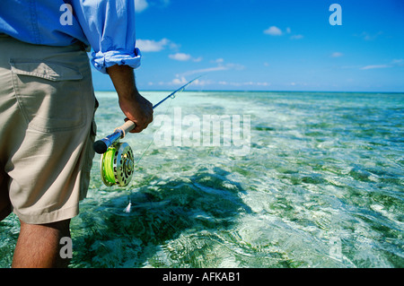 Fliegen Sie Fischer stehen im flachen Wasser auf der Suche nach Bonefish und in Belize Karibik veröffentlicht Modellbild erlauben Stockfoto