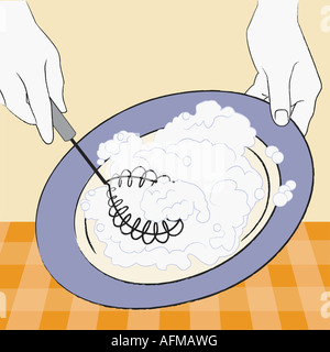 Person s Hände mischen Zutaten mit einem Schneebesen Stockfoto