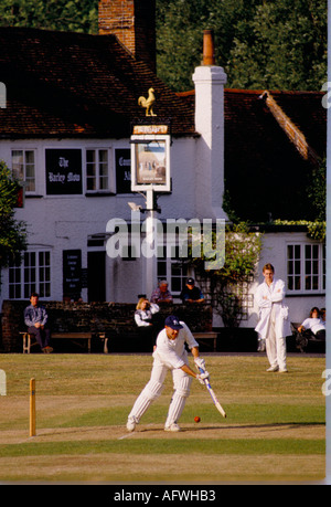 Dorf Cricket in Tilford, Surrey. Die Gerste mähen das Dorf lokalen Pub, wo es Erfrischungen am Ende des Spiels 1990s UK. HOMER SYKES Stockfoto