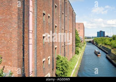 Kanalboot vorbei an stillgelegten Lagerhalle in Trafford Park Manchester uk Stockfoto