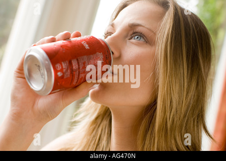 Mädchen trinken von Cola kann Zinn Stockfoto