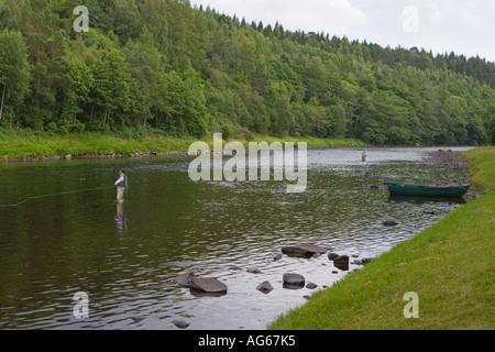Fliege Fischer in Watvögeln, mit Landungsnetz, waten am Fluss Spey, Speyside, Castle Grant Beat, Scottish Highlands, Schottland großbritannien Stockfoto
