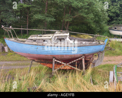 Altes Boot mit blauen Rumpf auf dem land Stockfoto