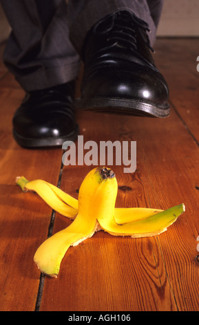 Geschäftsmann, Schritt auf Bananenschale im Büro uk Stockfoto