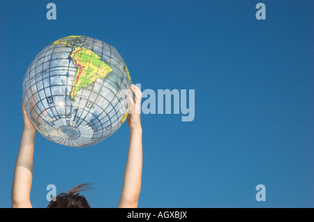 Junge Womans Hände halten Globus Stockfoto