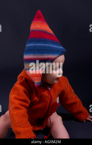 Baby in bunten Wollsachen Stockfoto