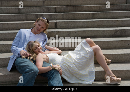 Junge Frau, die ihren Kopf auf einen jungen Mann Schoß ruhen Stockfoto