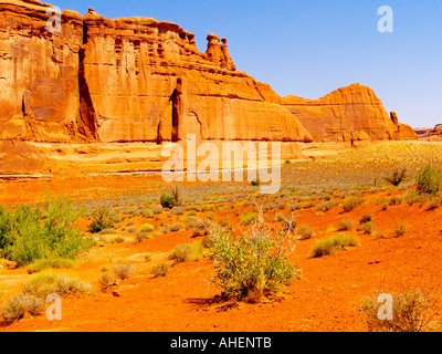 Massiven roten Felsformationen und Chaparral in der Sommerzeit im Arches National Monument im Südosten von Utah Stockfoto