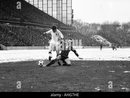 Fußball, Bundesliga, 1969/1970, Wedau Stadion Duisburg, MSV Duisburg vs. Borussia Moenchengladbach 0:1, auf Schnee Boden, Szene des Spiels übereinstimmen, Duell zwischen Herbert Wimmer (Gladbach) links und Michael Bella (Duisburg) Stockfoto