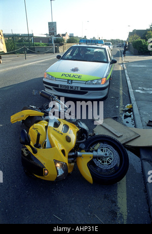 Motorrad auf seiner Seite vor einem Polizeiauto nach einem Unfall, Großbritannien UK Stockfoto