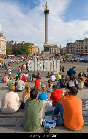 Touristen und Einheimische auf den Stufen der National Gallery an einem heißen Sommertag mit Blick auf dem Trafalgar Square. Stockfoto