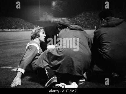 Fußball, Bundesliga, 1970/1971, Borussia Moenchengladbach gegen Rot-Weiss Oberhausen 6:0, Boekelberg Stadion, verletzte Fußballspieler, Günter Netzer (MG) auf Grund gelaufen, Helfer Pflege für ihn Stockfoto