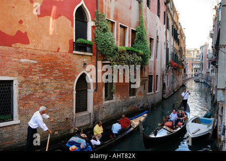 Zwei Gondoliere Wassertaxis, die Verhandlungen über einen schmalen Kanal in Venedig Italien Stockfoto