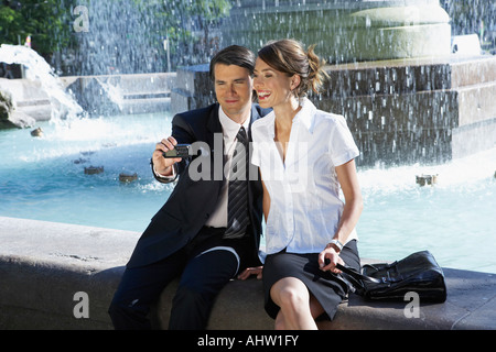 Junges Paar unter Bild neben Brunnen zusammen. Stockfoto