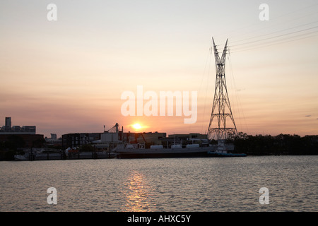 Kraft Übertragung Linien Strommast über Fluss am Abend Sommer Sonnenlicht Brisbane Queensland QLD Australien Stockfoto