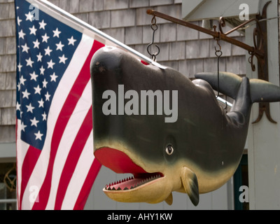 Ein Modell der Kiefer hängen neben der amerikanischen Flagge vor einem Geschäft in Menemsha, Martha es Vineyard USA Stockfoto