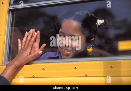 Afrikaner - Kind schaut durch das Fenster der Schule Bus als ihre Mütter Hand berührt das Fenster Stockfoto