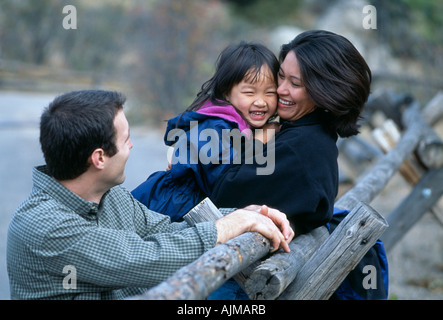 Eine Familie mit drei, die Spaß an einen hölzernen Zaun in der Nähe von Lumpy Ridge Rocky Mtns CO Stockfoto