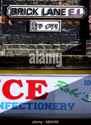 Eine Straße Zeichen der Brick Lane in Englisch und Bengali auf einem geritten Graffitiwand in Brick Lane East London Vereinigtes Königreich Stockfoto