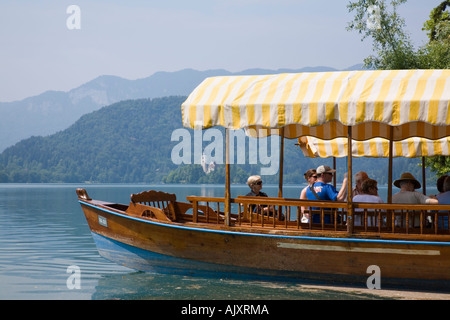 Bleder See im Sommer bei Touristen auf traditionellen hölzernen Pletnja Ruderboot Reise zu Str. Marys Kirche Insel. Bled Slowenien. Stockfoto